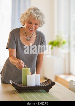Woman lighting candles Stock Photo