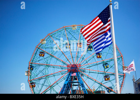 Flags in front of Ferris wheel Stock Photo