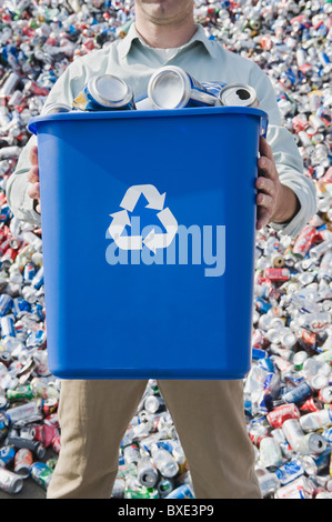 Man holding blue bin Stock Photo