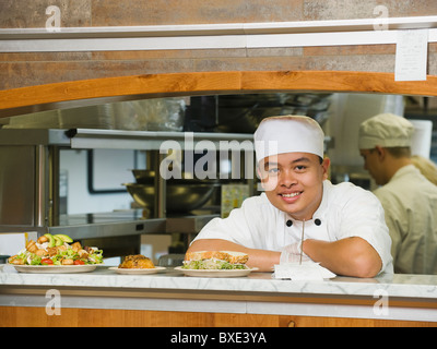 Chef leaning on counter Stock Photo