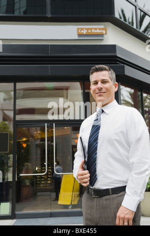 Businessman standing in front of building Stock Photo