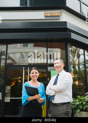 Business owners standing in front of building Stock Photo