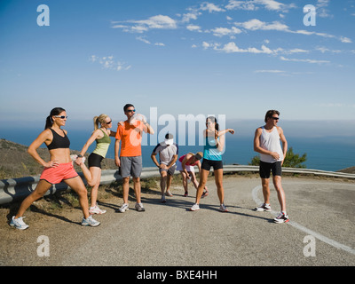 Runners stretching on a road in Malibu Stock Photo