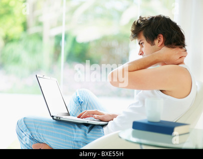 Relaxed man browsing the internet Stock Photo