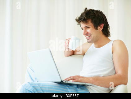 Relaxed man browsing the internet Stock Photo