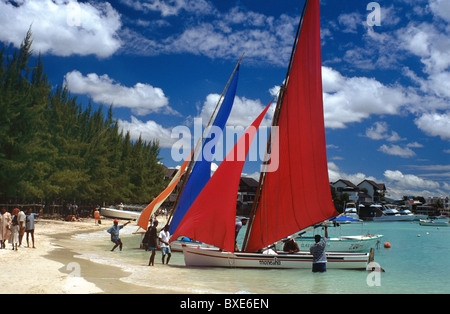 Colourful Yachts with Red & Blue Sails on the Sandy Beach at Grand Bay or Grande Baie, Mauritius Stock Photo