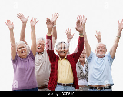 Group of senior with their arms raised Stock Photo