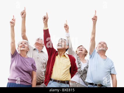 Group of seniors pointing up Stock Photo