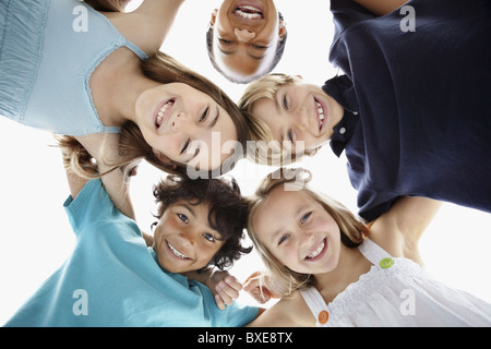 Happy children huddled together Stock Photo