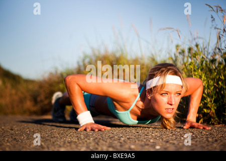 Runner doing push ups Stock Photo