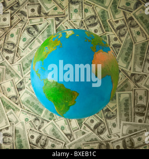 Globe on top of money Stock Photo