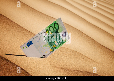 100 euro bill in sand Stock Photo