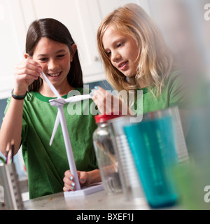 Two girls looking at model windmill Stock Photo