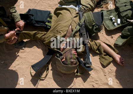 A simulated wounded soldier lies on the ground during Israeli army urban warfare drill in a military base in Israel Stock Photo