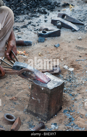 Gadia Lohar. Nomadic Rajasthan man forging axe heads. India's wandering blacksmiths. India Stock Photo