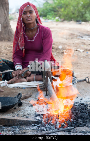 Gadia Lohar. Nomadic Rajasthan young woman tending a furnace. India's wandering blacksmiths. India Stock Photo