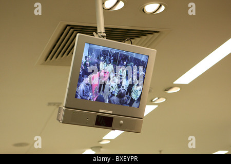 CCTV Monitor in M&S Oxford Street showing stand off with police and protesters Stock Photo