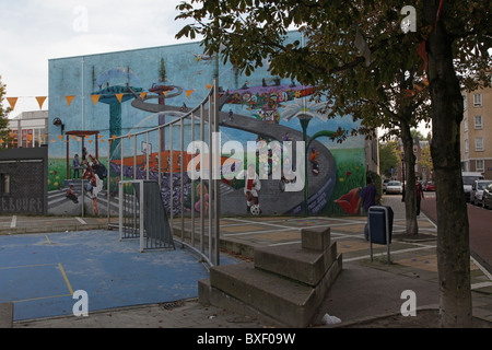Graffiti on wall in the background, playground in front Stock Photo