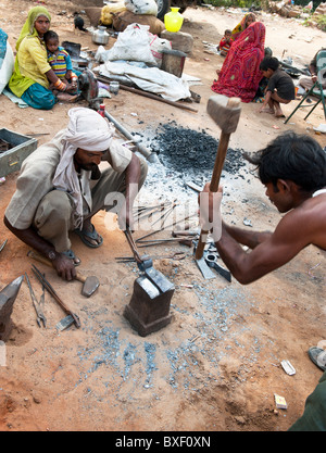 Gadia Lohar. Nomadic Rajasthan men forging metal axe heads. India's wandering blacksmiths. India Stock Photo