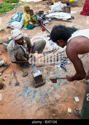 Gadia Lohar. Nomadic Rajasthan men forging metal axe heads. India's wandering blacksmiths. India Stock Photo