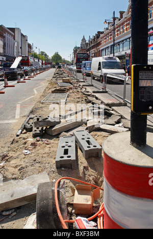 Repairing the central reservation area of Brixton Road South London UK Stock Photo