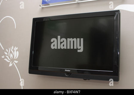 flat LCD television hanging on wall Stock Photo