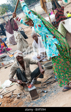 Gadia Lohar. Nomadic Rajasthan men and woman forging metal axe heads. India's wandering blacksmiths. India Stock Photo