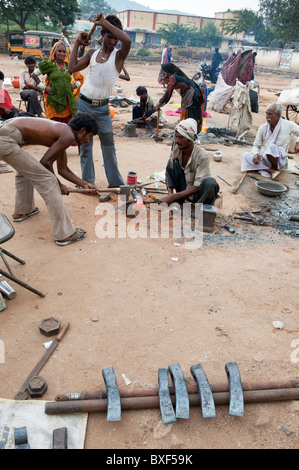 Gadia Lohar. Nomadic Rajasthan men forging metal axe heads. India's wandering blacksmiths. India Stock Photo