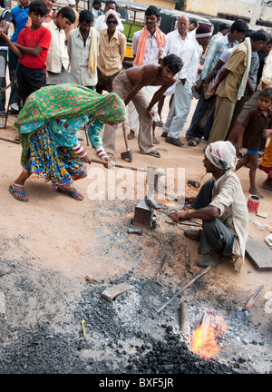 Gadia Lohar. Nomadic Rajasthan men and woman forging metal axe heads. India's wandering blacksmiths. India Stock Photo