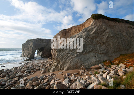 Gate in the rocks under clouded sky, Cote Sauvage, Quiberon, Brittany, France, Europe Stock Photo
