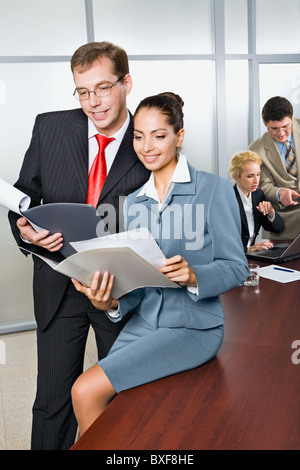 Two business people are looking in the documents Stock Photo