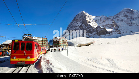 Jungfraujoch train at Kleiner Scheidegg in winter with The Eiger (left) then The Monch Mountains. Swiss Alps Switzerland Stock Photo
