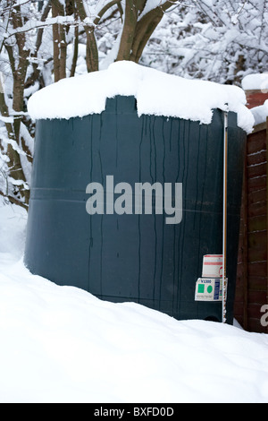 home heating oil tank covered in snow on a cold snowy winters day Northern Ireland Stock Photo