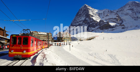 Jungfraujoch train at Kleiner Scheidegg in winter with The Eiger (left) then The Monch Mountains. Swiss Alps Switzerland Stock Photo
