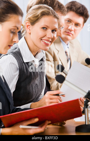 Portrait of successful young woman between her colleagues Stock Photo