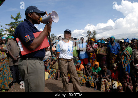 Employees of World Food Programme WFP addressing to internally displaced people at a food distribution point in North Kivu province DR Congo Stock Photo