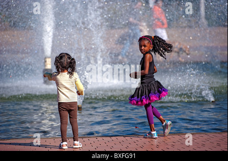 Girls are playing at the Bea Evenson, Memorial Fountain, in Balboa Park, San Diego CA Stock Photo