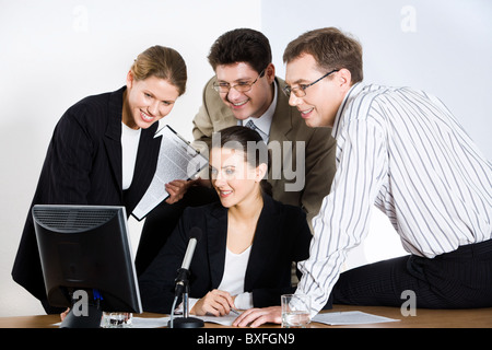 Team of four business people working together Stock Photo