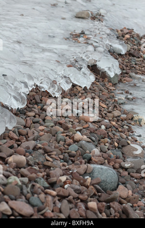 Ice covered pebbles on a beach in Lake Superior. Stock Photo