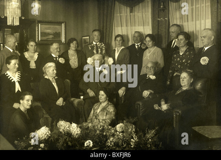 Germany, circa 1932, birthday party, person celebrating his 70th birthday, aged 70, family, friends, great day, old man, sitting, flowers, present, presents, guests, clothes, solemnly, senior, seniors, celebration, celebrating, generation, age, middle classes, bourgeoisie, 1930s, 30s, 20th century, , Additional-Rights-Clearences-Not Available Stock Photo