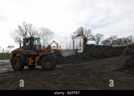 Front loader working at composting centre Stock Photo