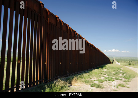 US border fence on Mexican border.  This is in a remote area of Arizona in the Tucson sector of the US Border Patrol. Stock Photo