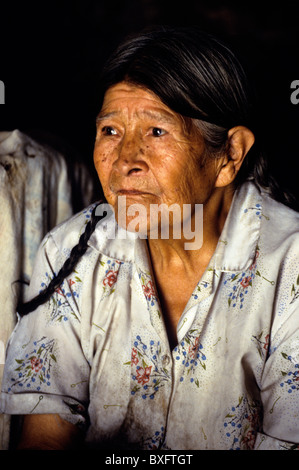 Old woman selling chicha (corn based alcoholic drink) in the Incan village of Ollantaytambo- Sacred Valley, Peru. Stock Photo