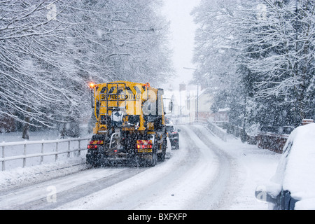 Snowplough clearing road, Surrey, UK Stock Photo