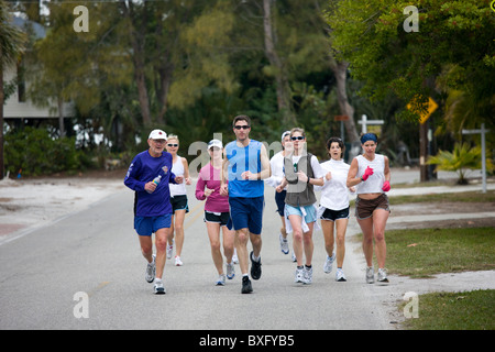 Group of joggers keeping fit on early morning jog, Anna Maria Island, Florida, United States of America Stock Photo