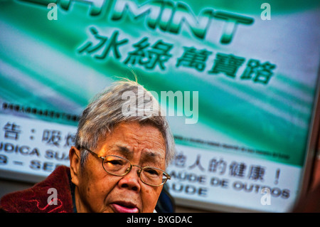 Expressive older Asian woman with head of full gray hair Stock Photo