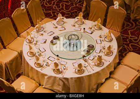 Elaborate round table decoration in hotel dining room Stock Photo