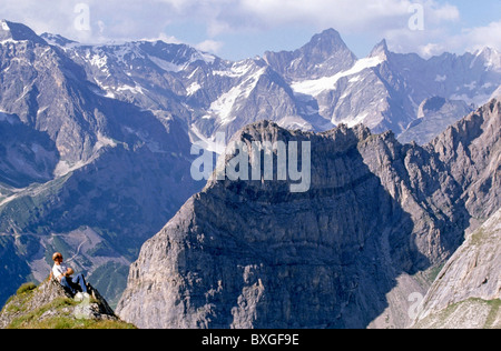 French Alps - Hiker looks down at the view from high up a mountain in the Vanoise National Park, France. Stock Photo