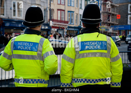 Two Welsh Heddlu or police officers, dressed in riot gear on the ...