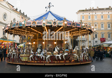 Rome, piazza Navona Christmas market, merry go round with passerbies Stock Photo